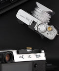 Top view of camera with Metal Hot Shoe Thumb Up Grip For Fuji X100V X100VI Camera Black, Ergonomic Hand Rest Enhancing Stability.