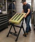 Man adjusting Heavy Duty Welding Table 36x18 Inch Portable Workbench On Wheels With Braking Lockable Casters in workshop