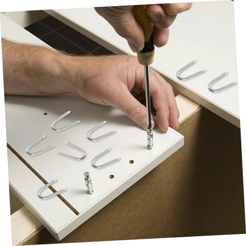 50 Piece U Shaped Fencing Staples being installed using a screwdriver, showcasing their sharp tips and strong hold for fencing.