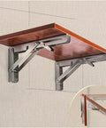 Heavy Duty Rock Solid Folding Wall Mount Shelf Brackets Crafted From Premium Stainless Steel With A Durable Matte Black Coating, showcasing a wooden shelf.