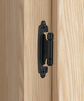 Rock Solid Matte Black Cabinet Hinges Featuring A Nifty 1/2 Inch Overlay Design With Self Closing Action installed on a wooden cabinet.