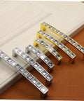 Crystal U Shaped Drawer Pull Handles In Bright Chrome With Screws on display, mix of silver and gold finish, elegant design