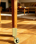 Close-up of furniture leg with Two-Pack Metal Swivel Cup Casters, Square Cup Style Furniture Wheels for tables, 2.48 inch diameter.