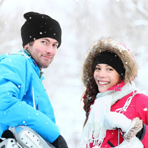 Couple smiling in snow, wearing black knit hats and winter jackets, showcasing Three Hole Knit Ski Mask Balaclava for Winter Warmth