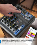 Person adjusting 4 Channel Digital USB Bluetooth Pro Audio Mixer With MP3 Playback, USB Flash and PC Input