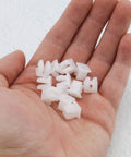 Twenty Pack White Plastic Vehicle Screw Grommets Expandable Insert Nuts in hand showing heavy duty mounting clips for 7x7mm holes.