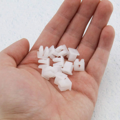 Twenty Pack White Plastic Vehicle Screw Grommets Expandable Insert Nuts in hand showing heavy duty mounting clips for 7x7mm holes.