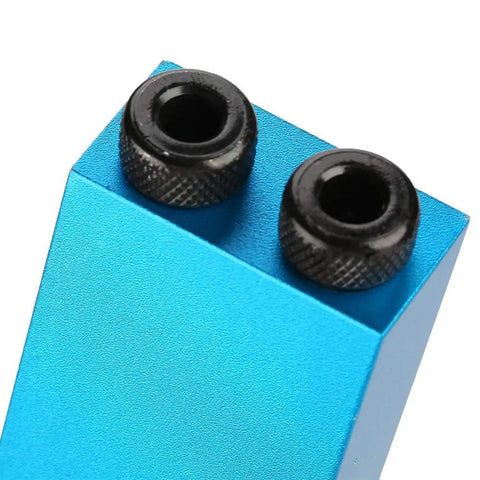 Close-up of blue Pocket Hole Jig Kit For Woodworking With 15 Degree Oblique Hole Locator showing steel bushings in aluminum body.