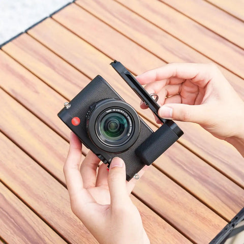 Hands holding D-LUX8 camera with Durable Aluminum Hand Grip, L Shape Bracket, Arca Quick Release Plate, and Anti Slip Microfiber Pad.