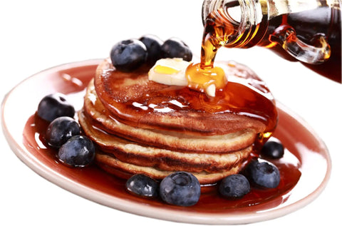 Stack of pancakes with blueberries and maple syrup being poured, representing use for Maple Syrup Filters Set 7 Piece Kit.