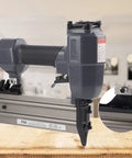 Rock Solid Heavy Duty Pneumatic Brad Nailer And Air Powered Stapler For No Fuss Woodworking and DIY Carpentry Projects Featuring Premium Aluminum Alloy Construction, close-up of tool on wood