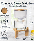Glass Alkaline Water Dispenser With pH Up To Nine And Filter System, countertop design with bamboo base, 17x11 inch dimensions.