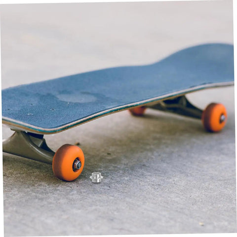 Durable Aluminum Inline Skate Spacers Kit 20 Pieces visible near skateboard on concrete surface