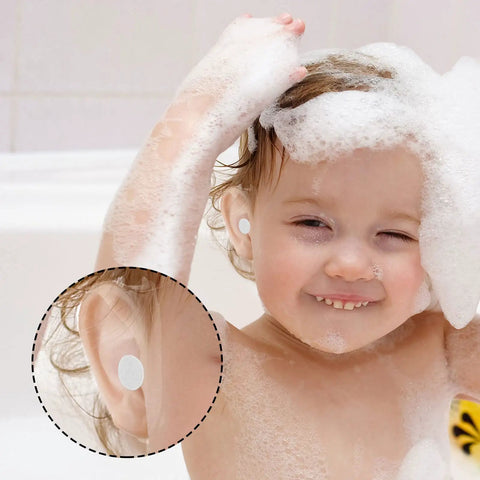 Smiling child in bath using 120 Pcs Disposable Baby Ear Covers For Shower And Bath Waterproof Ear Protection For Newborns And Kids, Soft Green.