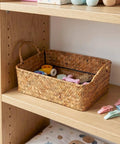 Spacious Open Top Seagrass Woven Storage Basket With Heavy Duty Handles For Kitchen Farmhouse Pantry Bathroom Towels Cosmetics And Hassle Free Daily Organization Goals, filled with colorful clips on a shelf.