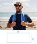Man holding Chilly Pad Cooling Towel For Sports And Outdoors, Hyper Evaporative, 33 by 13 inches, at the beach.