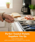 Hand holding Retro 1945 Style Handheld Cast Aluminum Sandwich Maker And Pie Iron Grill over stovetop, cooking toasted pockets.