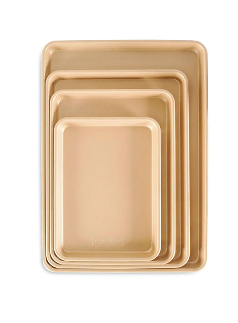 Set of stacked nonstick aluminum half sheet pans, various sizes, including 13 by 18 inches with reinforced steel rim for baking, hand wash only.