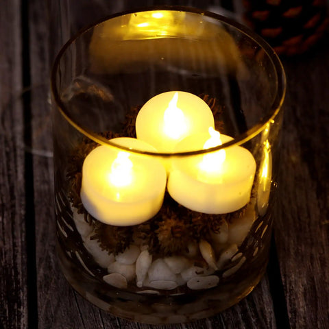 24 Pack Flickering LED Tea Lights With Timer 6 Hour Auto On Off Battery Operated Flameless Tealights glowing in glass vase