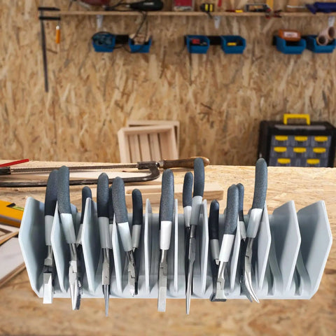 Top view of Two Piece Tool Drawer Organizers Storage Holder With Pro Grade Adjustable Hooks for pliers in a workshop setting.