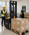 Top Tier Electric Walkie Pallet Stacker With Huge 1500Kg Capacity transporting boxes in a warehouse, operated by a worker.