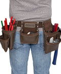 Heavy Duty Leather Tool Apron With Seven Pockets, Hammer Holder And Rivet Reinforced Edges For Pro Grade Toughness Full Grain Leather Steel Hardware And Ample Storage For Quick Efficient Workdays worn by person with tools