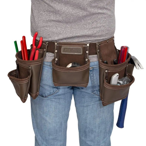 Heavy Duty Leather Tool Apron With Seven Pockets, Hammer Holder And Rivet Reinforced Edges For Pro Grade Toughness Full Grain Leather Steel Hardware And Ample Storage For Quick Efficient Workdays worn by person with tools