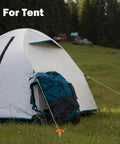 Heavy Duty Tent Stakes 20 Pack 9.75 Inch Ground Pegs securing a tent in a grassy field with orange T-shaped tops.