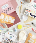 Air Dry Clay Kit For Adults Beginners Home Pottery Craft Set with tools, paints, brushes, sealant, and guides on a table.