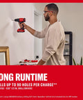 Badass 20V Cordless Drill And Impact Driver Combo Kit With Two 2Ah Lithium Batteries And Charger in use, drilling into a wall.