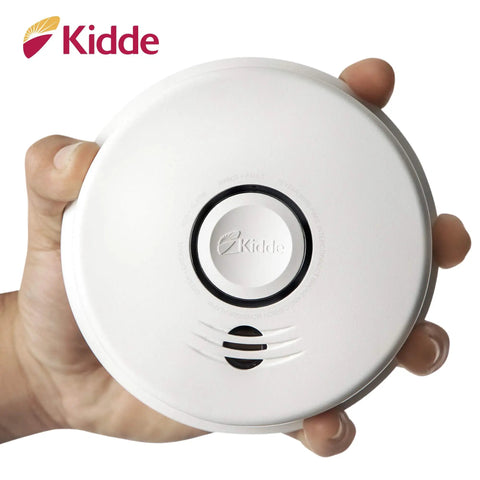 Hand holding Smoke And Carbon Monoxide Detector With 10 Year Battery And Voice Alert Interconnected Combo Alarm For Your Home Safety