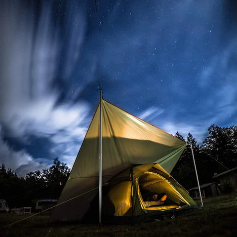 Night camping setup with adjustable telescopic tarp poles for camping and hiking, lightweight dope stainless steel tent poles shown