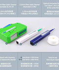 Front view of fiber optic cleaner kit: green case with three pen-style cleaners (white, green, blue) and ribbon roll.