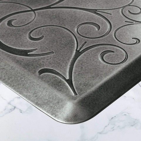 Close-up of ergonomic anti-fatigue floor mat with subtle floral design, part of the Bella Collection, polyurethane, water-resistant, USA-made.