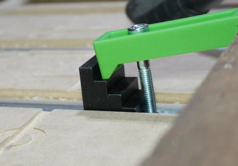 Get Your Work Locked Down Tight With These 10 Pcs 4 Step Clamp Blocks Perfect As CNC Spacer For Hold Down Clamps Super Durable And Precision 3D Printed Gear You Need To Crush Any Project. Close-up of black clamp block secured with green clamp on worktable.