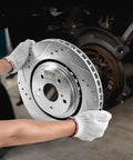 Person holding All In One Front And Rear Brake Kit With Drilled And Slotted Rotors And Ceramic Pads For Toyota Sienna, Highlander