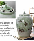 Total Pantry Flex That Keeps Grains Sealed Tight This Large Green Ceramic Rice Jar features a floral design and a large lid.