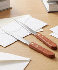 Two Pack Letter Openers With Wood Handle And Stainless Steel Blades For Grab And Go Envelope Slitters on desk with mail