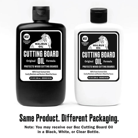Two bottles of Food Safe Cutting Board Oil For Wood Butcher Block Kitchen Workhorse 8 Oz Bottle With Beeswax Fractionated Coconut Oil Mineral Oil And Vitamin E Easy To Apply FDA Compliant For Food Contact And Proudly Made In The USA in black and white packaging.