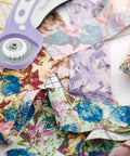 Headley Tools rotary cutter, 45mm blade, purple handle, on colorful fabric strips.