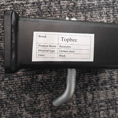 Close-up of black carbon steel Trailer Hitch Reducer Sleeve From Two And A Half Inch To Two Inch with label and pin.