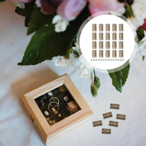 Antique Copper Mini Box Hinges Set 2 Inch With Screws For Jewelry Boxes Drawers And Wooden Chests Perfect For DIY Crafts And Small Projects 50 Piece Kit By ELEOUTI next to wooden box with flowers and rings