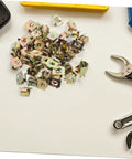 50Pcs Gold Iron Captive Nut U-Clip Fasteners for Car Bumper Grill and License Plate Mounting scattered on a table.