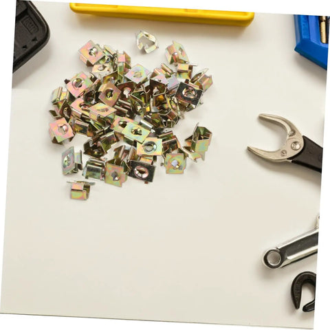 50Pcs Gold Iron Captive Nut U-Clip Fasteners for Car Bumper Grill and License Plate Mounting scattered on a table.