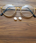 Push In Silicone Nose Pads For Glasses 50 Pack Non Slip Waterdrop Cushions Transparent Anti Sweat next to golden eyewear.