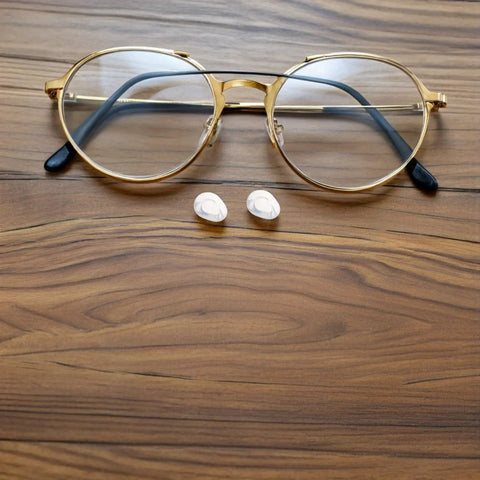 Push In Silicone Nose Pads For Glasses 50 Pack Non Slip Waterdrop Cushions Transparent Anti Sweat next to golden eyewear.