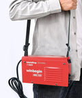 Person holding 125A 110V Mini Arc Welder With True 125A Output For DIYers On The Go Portable IGBT Inverter Stick Welder with strap