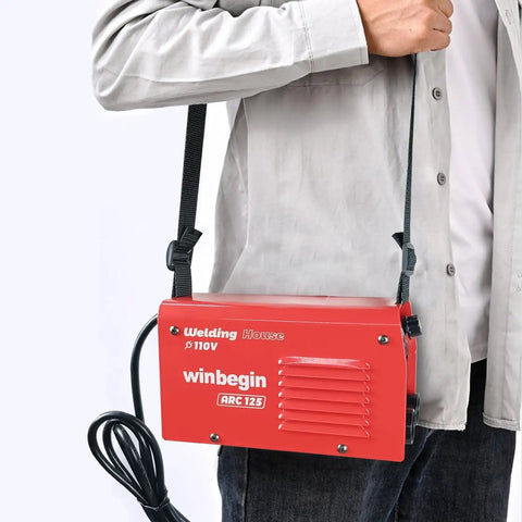 Person holding 125A 110V Mini Arc Welder With True 125A Output For DIYers On The Go Portable IGBT Inverter Stick Welder with strap