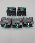 Close-up of five Ten Pack Snap In Momentary Push Button Switch Contact Block With Screw Clamp Terminals for industrial use.