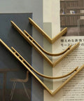 Heavy Duty Shelf Brackets Wall Mount Kickass Brass Metal Supports L Shape set on a magazine page for floating shelves.